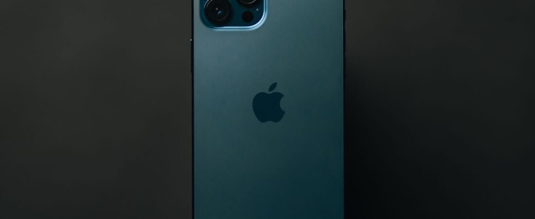 Pro-tier iPhone shown from the back in a dark studio, highlighting the rear triple camera