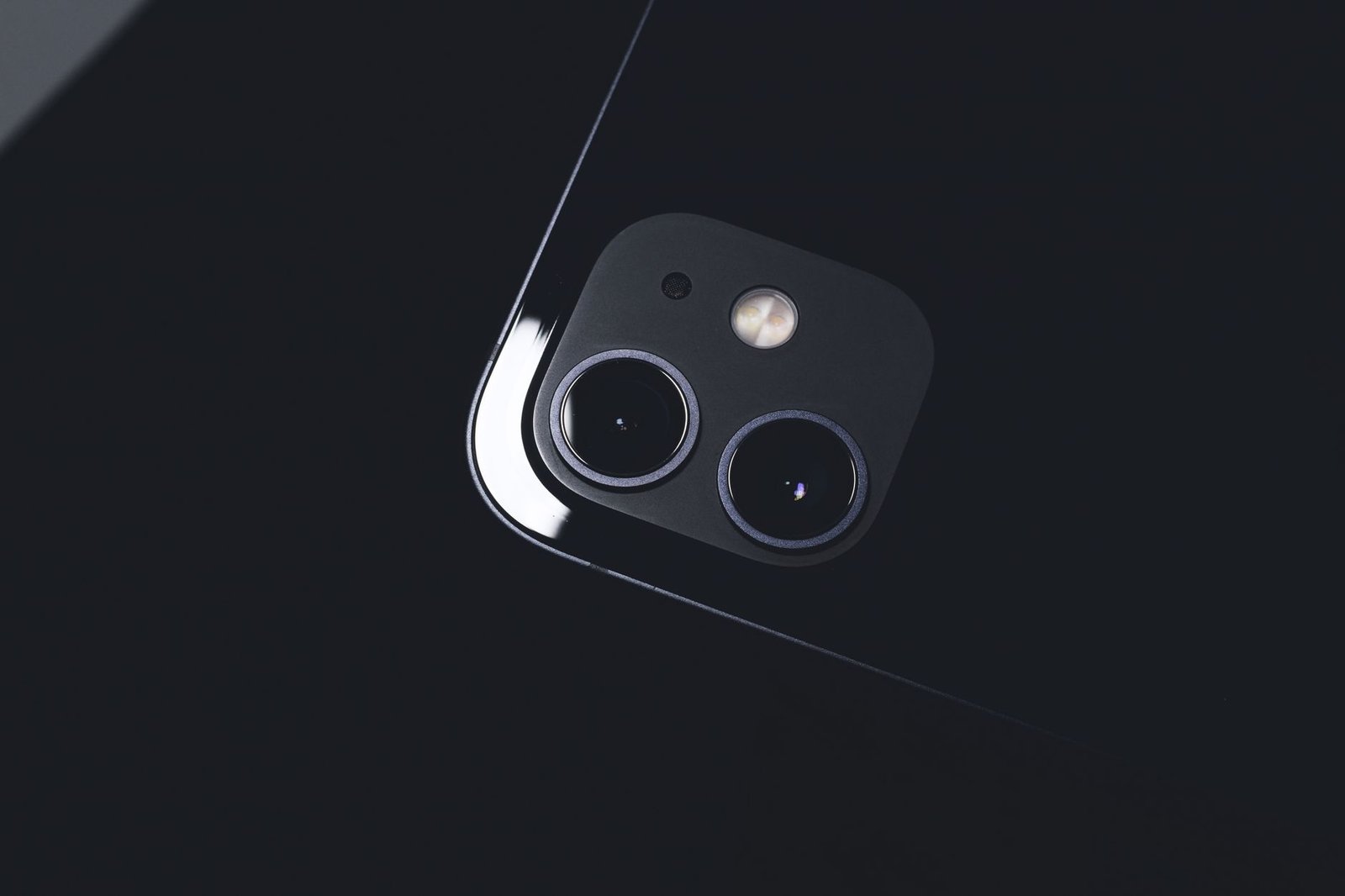Close-up of an iPhone rear camera lens illustrating the variable aperture upgrade