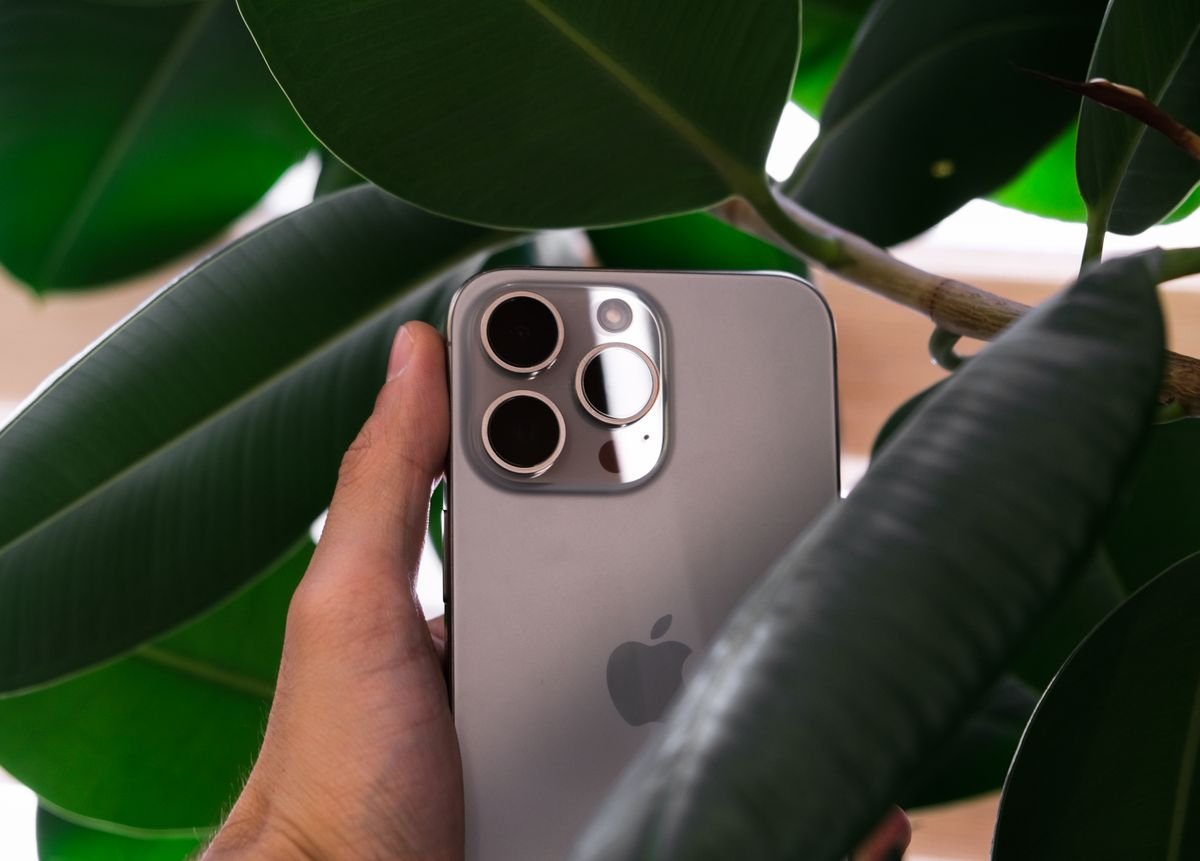 A hand holding a current iPhone Pro, a reminder there is no iPhone 18 this year at the fall event