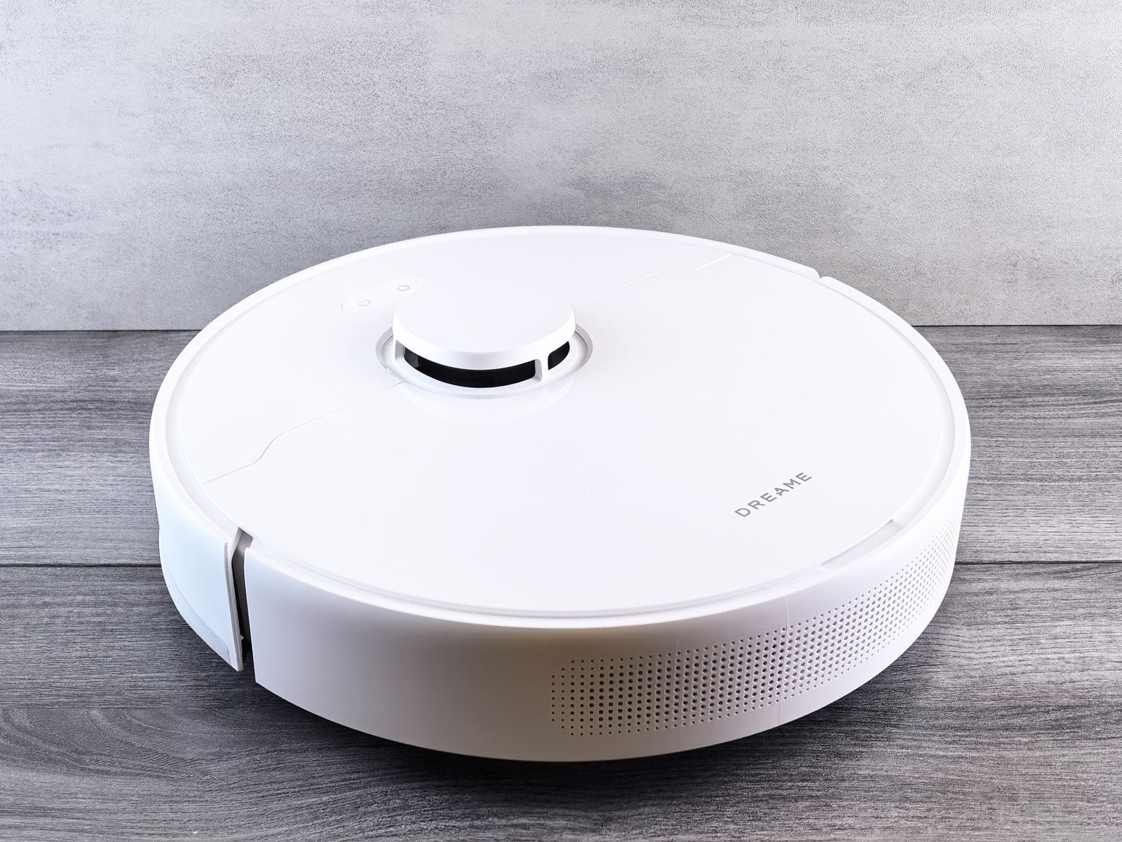 Sleek white robot vacuum shown as a product, representing spec-sheet feature overload.