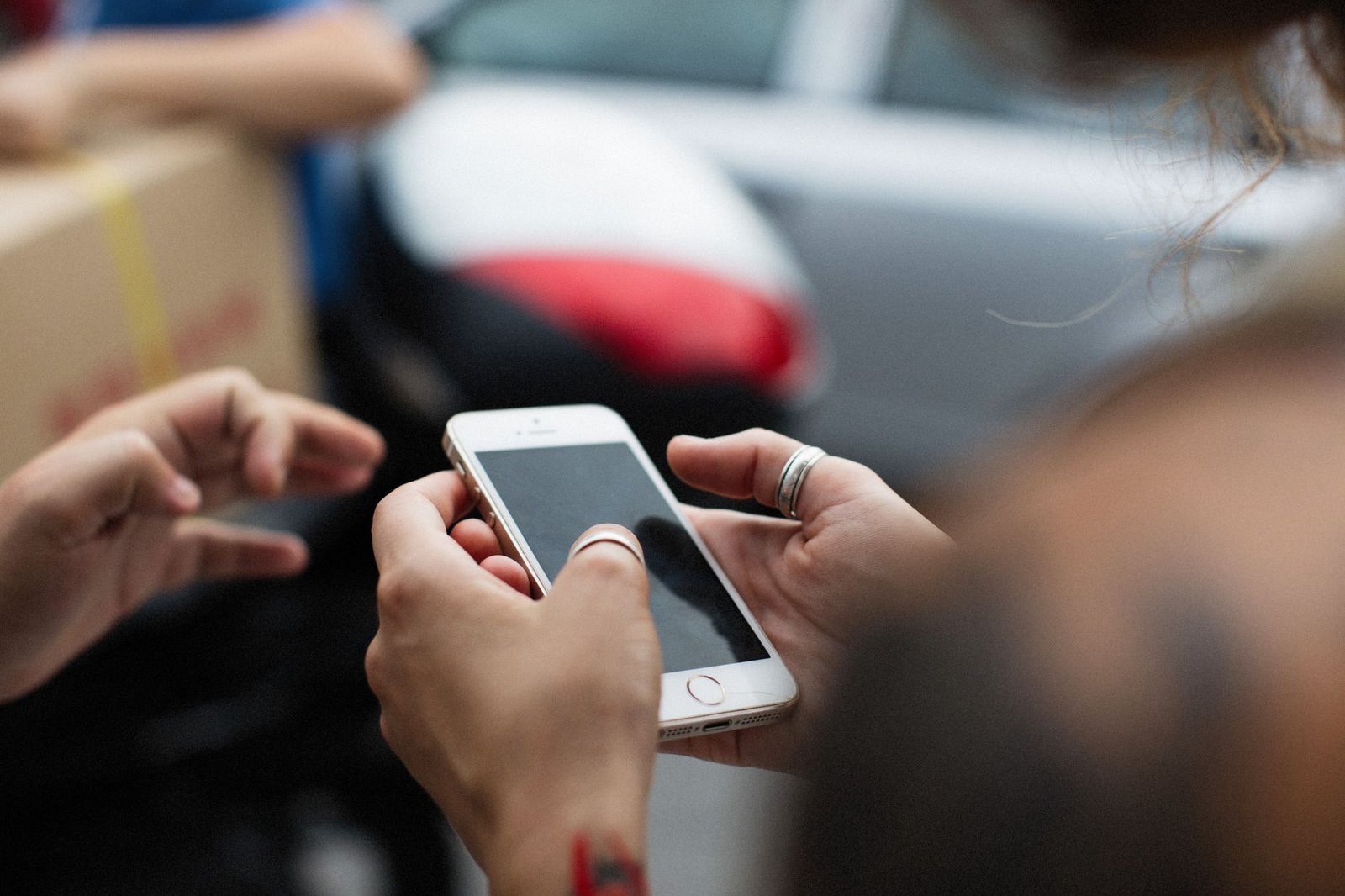 Person holding an iPhone while deciding whether to upgrade to a new model